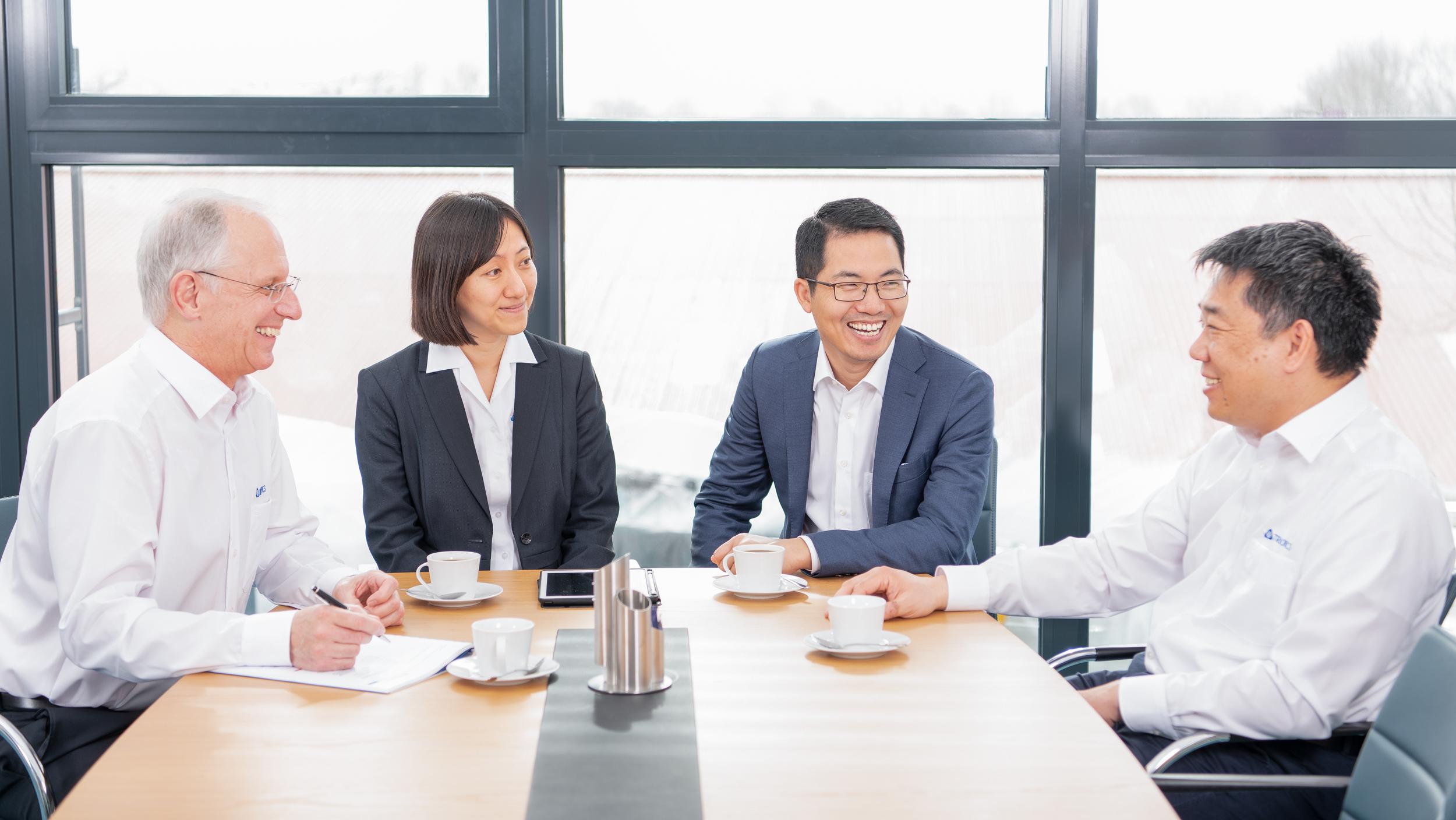 Four people during a business meeting