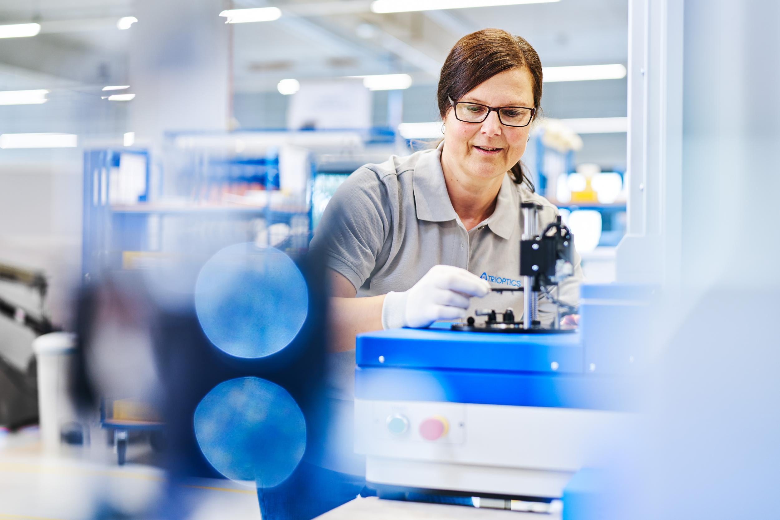 Woman in front of an OptiCentric machine